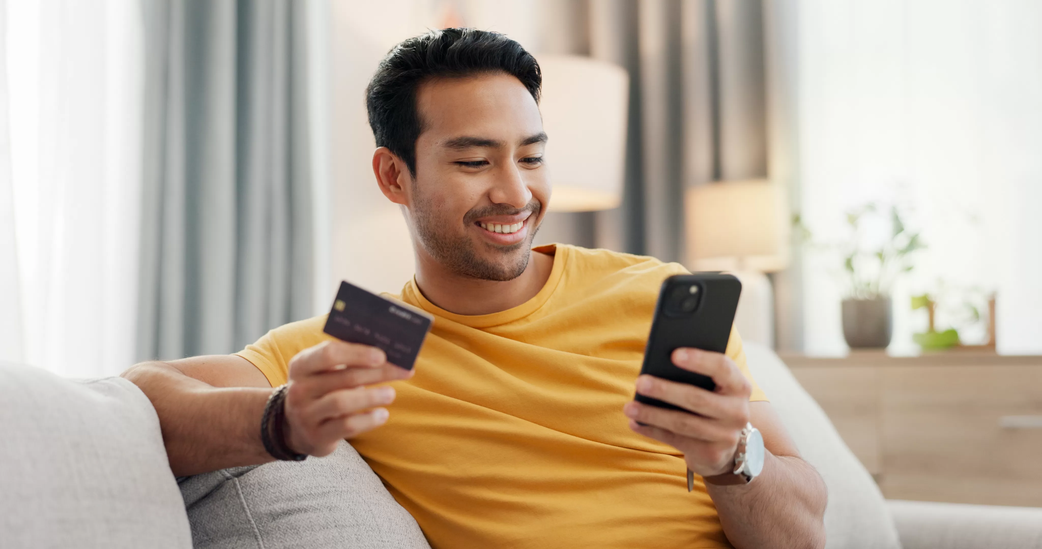 Member using a Transport CU Visa credit card on a phone at home